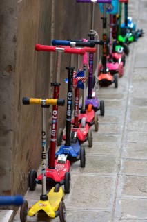 Parked children's scooters in front of a kindergarten, Venice, Veneto, Italy