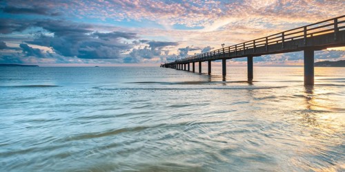 Pier on the beach of the Baltic Sea at sunrise, Baltic resort Binz, Rügen island,