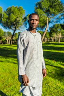 Portrait of a senegalese man wearing a dashiki in a park, representing african culture and muslim