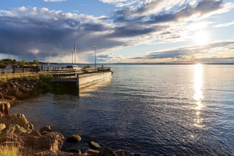 Evening with sun and clouds on Lake Siljan in Rättvik harbour, Dalarnas län, Sweden