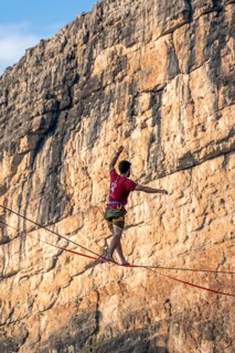 Slackliner in the mountains, mountain peaks of the Brenta Mountains, at Refugio Francis Fox