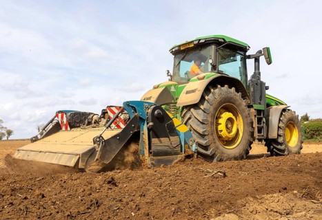 John Deere 8R 340 tractor engaged in field work operating an Agri-World FTC series soil tiller,