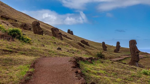 A path snakes across a hill past several Moai statues, The Moai Statues on Easter Island in the