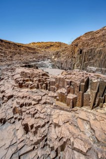 Dry river valley with basalt rocks, rock formation Organ Pipes, Damaraland, Kunene, Namibia