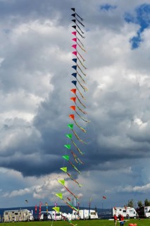 Colourful, strung kites flying in the sky, garland, kite festival in Vinsebeck, mobile homes,