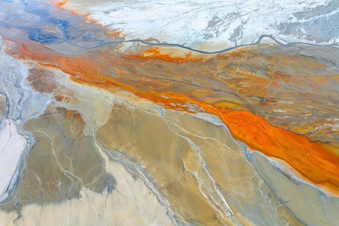 A captivating aerial view depicting multicolor abstract textures, blending earthy tones with