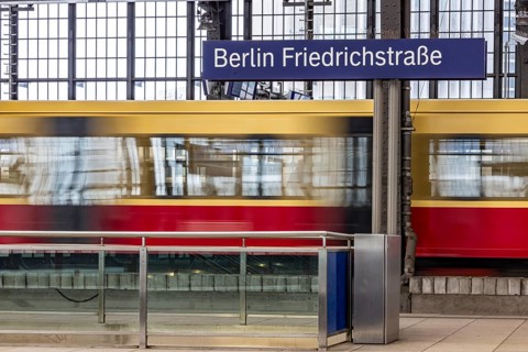 Friedrichstraße railway station in Berlin. Platform with S-Bahn and station sign. motion blur.