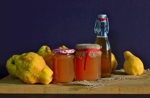 Still life with quinces, homemade quince jelly and quince liqueur, autumn, Germany
