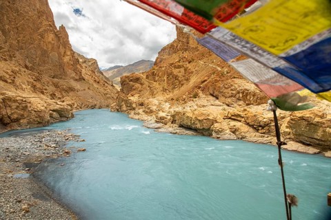 The turquoise Zanskar River winds through rugged canyons near Phugtal Gompa in Ladakh. Vibrant