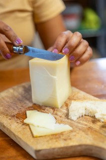 A woman relishes a cheese inside a rustic shelter in Gorbea Natural Park, Basque Country, Spain.