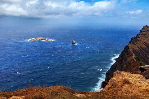 View from a cliff of small islands in the blue sea, the landscape of Easter Island in the Pacific