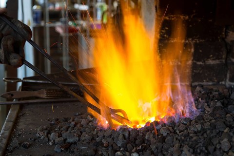 A blacksmith forging, working at the Ehnert forge in Dresden-Bühlau, Saxony, Germany