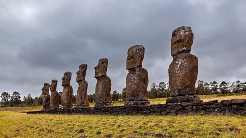 A series of Moai statues on Easter Island under a cloudy sky, The Moai statues on Easter Island in