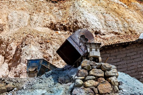 Rusty machine parts on a rocky hilly landscape in dry conditions, The silver mines near Potosi on