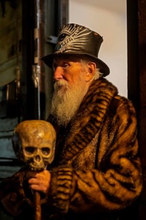 New Orleans, Louisiana - An old man on Frenchmen Street holds his cane decorated with a skull