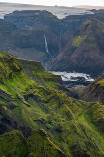 Moss-covered mountains at sunset, waterfalls on a cliff at Myrdalsjökull glacier, Pakgil, Iceland