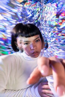 A futuristic Latin woman explores the vibrant and immersive world of the metaverse, surrounded by
