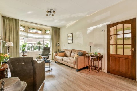 A comfortable living room designed for relaxation, featuring soft furnishings, natural light, and