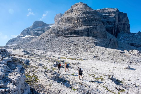 Three mountaineers on a hiking trail on the Grosté Plateau, Brenta Mountains, Parco Naturale