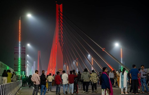 People gather on the newly inaugurated Kumar Bhaskar Varma Setu, a six-lane cable styled bridge