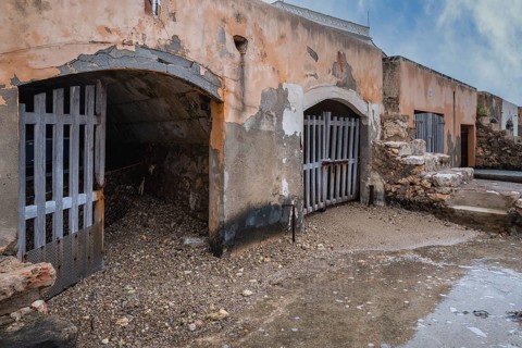 Old and dilapidated boat shelters that are not being used, old port area in Portocolom on the east