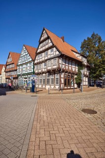 Historic half-timbered houses, trees, blue cloudless sky, crossing street Kleiner Plan with Am