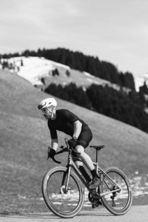 Road bike rider in spring in the Allgäu against the picturesque backdrop of the Alps, Bavaria,