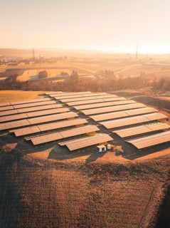 Large solar installation on a hilly field at sunrise, Magstadt, Germany