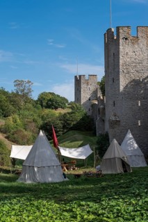 Camp in front of historic city walls with defence towers, Medieval Week, Hanseatic City of Visby,