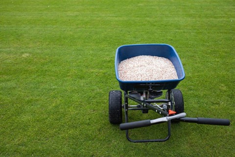 Fertilizer for grass on a football pitch. The letters marking is used to regulate the amount of
