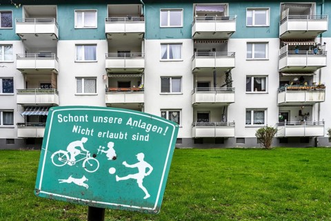 Residential development, rental apartments, prohibition sign on the lawn, meadow in front of the