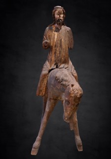 Palm tree donkey, wooden figure from around 1350, on a dark background, Diocesan Museum,