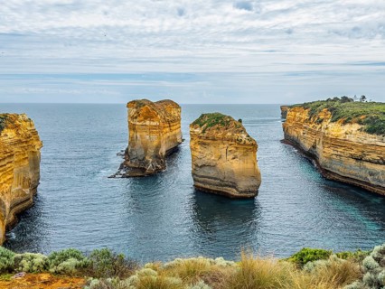 Awe inspiring coastal rock formations create a seascape as they rise from the ocean beneath a
