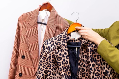 Fashion consultants selecting professional attire with diverse patterns. Two outfits, one with