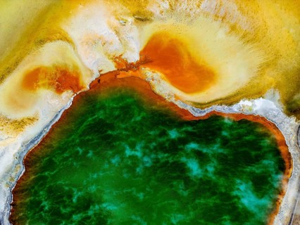 Aerial view capturing the vibrant colors and geothermal formations of Champagne Pool in Wai-O-Tapu
