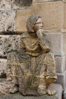 Sculpture in front of the old school building, art in public space, stone figure, sculpture by the