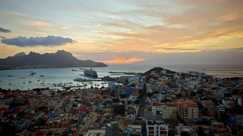 Panoramic view of Mindelo from above at sunset with colorful buildings, harbor and mountains, 'my