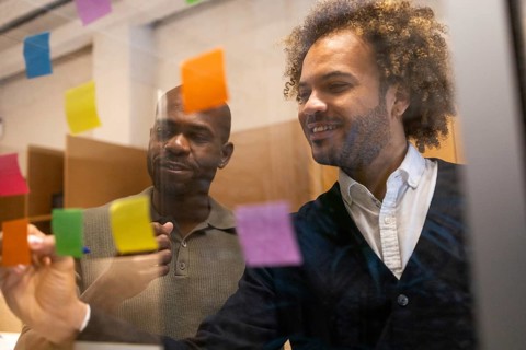 Professionals engage in a creative brainstorming session in a vibrant Barcelona coworking space,