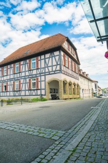 View of a traditional half-timbered house on a quiet street under a blue sky, Knittlingen, Germany