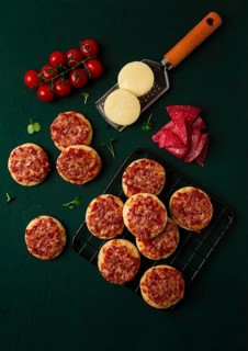 Mini pizzas, salami with mozzarella cheese, on the table, top view, no people