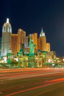 Nighttime urban scene in Las Vegas with brightly lit New York-New York Hotel and Casino, the Strip,