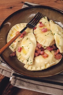 Dumplings, with fried prosciutto, a traditional dish of Polish cuisine, dumplings, top view,
