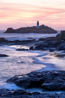 Godrevy Lighthouse, the lighthouse of Godrevy on Godrevy Island. In the evening at sunset. Long