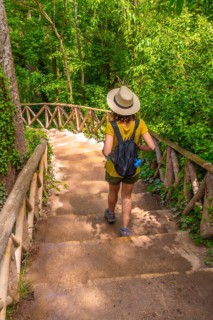 A female tourist walking down stairs in the Monasterio de Piedra Natural Park, Aragon