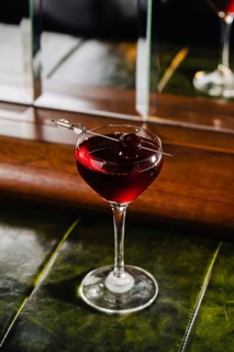 A rich berry infused gin cocktail with floral hints and sparkling wine splashes, served in an