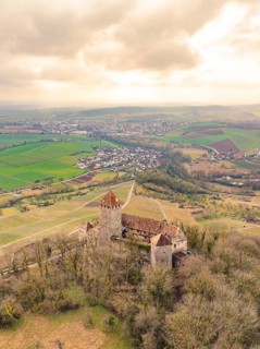 Castle nestled in wooded hills with extensive fields and a town, Lichtenberg Castle, Oberstenfeld,