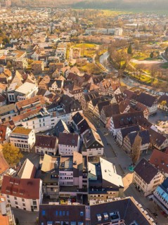 Aerial view of an old town with terraced houses and a river at dusk, Nagold, Black Forest, Germany