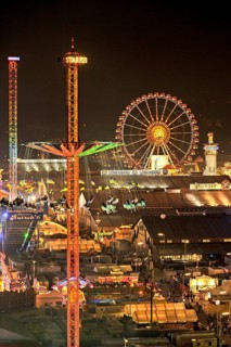 View over the Wies'n at night with illuminated carousel, Ferris wheel, stalls, beer tents and