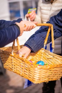 Person handing over Easter basket with colorful eggs outdoors, Easter campaign, Sindelfingen,