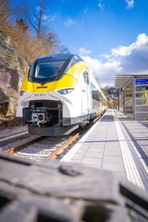 Close-up of a modern train on a platform under blue sky and clouds, Hermann Hesse Bahn, ZOB, Calw,